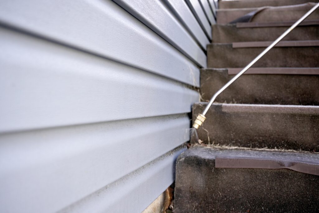 spraying pest treatment on stairs